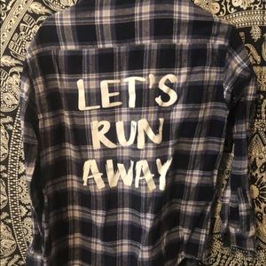 “Let’s Run Away” flannel shirt.